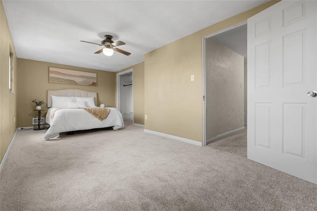 1670 Breining Street Pittsburgh, PA 15234 - Photo 20 of 39 a spacious bedroom with a bed and a chandelier