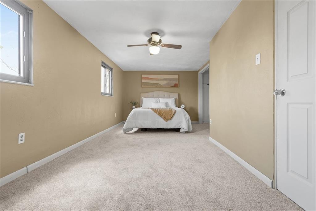 1670 Breining Street Pittsburgh, PA 15234 - Photo 21 of 39 a room with a bed and a chandelier