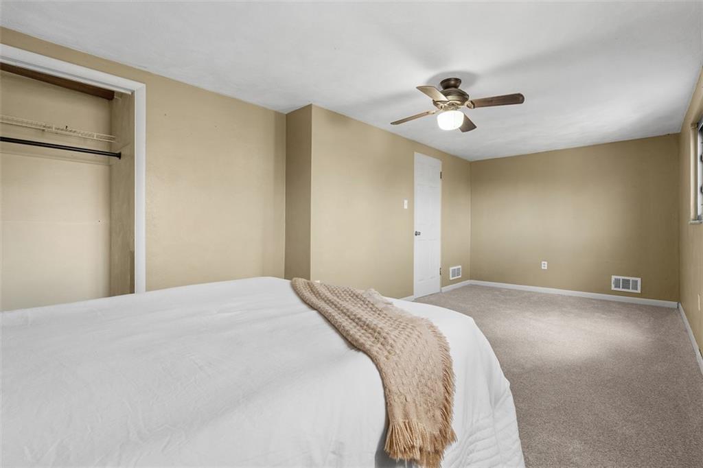 1670 Breining Street Pittsburgh, PA 15234 - Photo 22 of 39 a bedroom with a bed and a ceiling fan