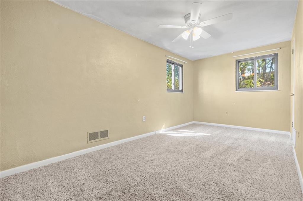 1670 Breining Street Pittsburgh, PA 15234 - Photo 28 of 39 an empty room with a chandelier fan and windows