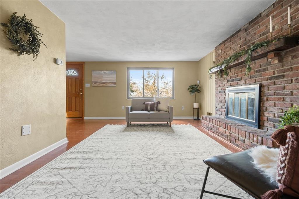 1670 Breining Street Pittsburgh, PA 15234 - Photo 8 of 39 a living room with furniture and a fireplace