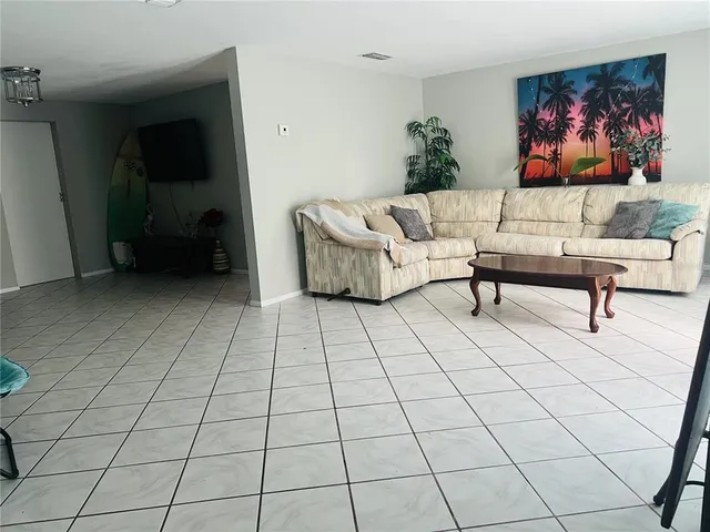 a living room with a couch and a rug