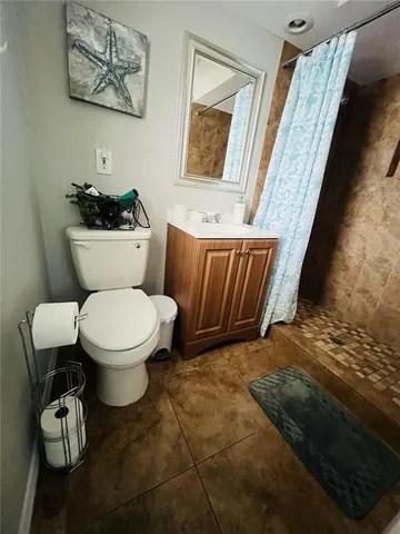 a white toilet sitting next to a bathroom sink