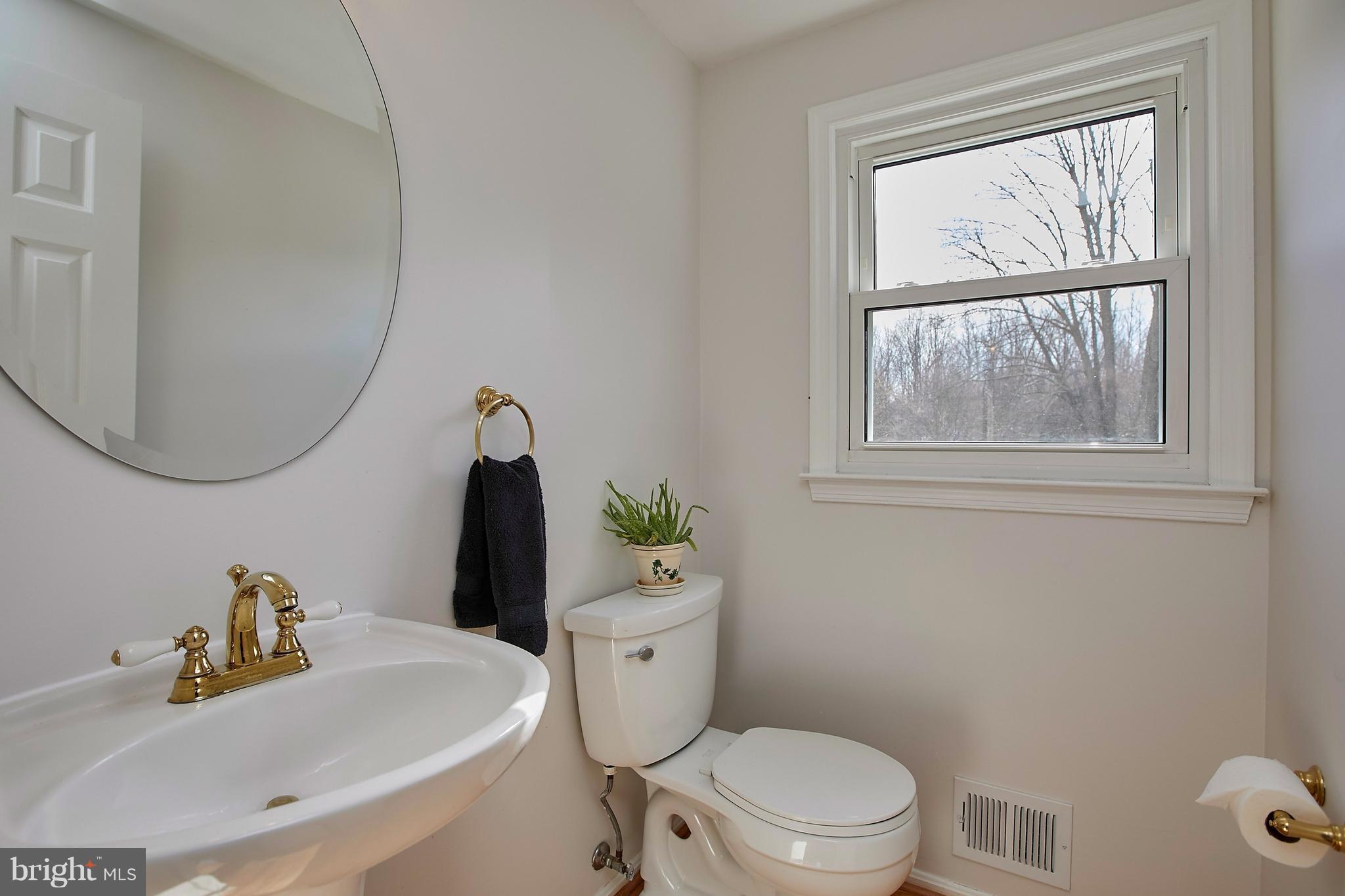 9961 Meadowlark Road Vienna, VA 22182 - Photo 14 of 30 a white toilet sitting next to a bathroom sink