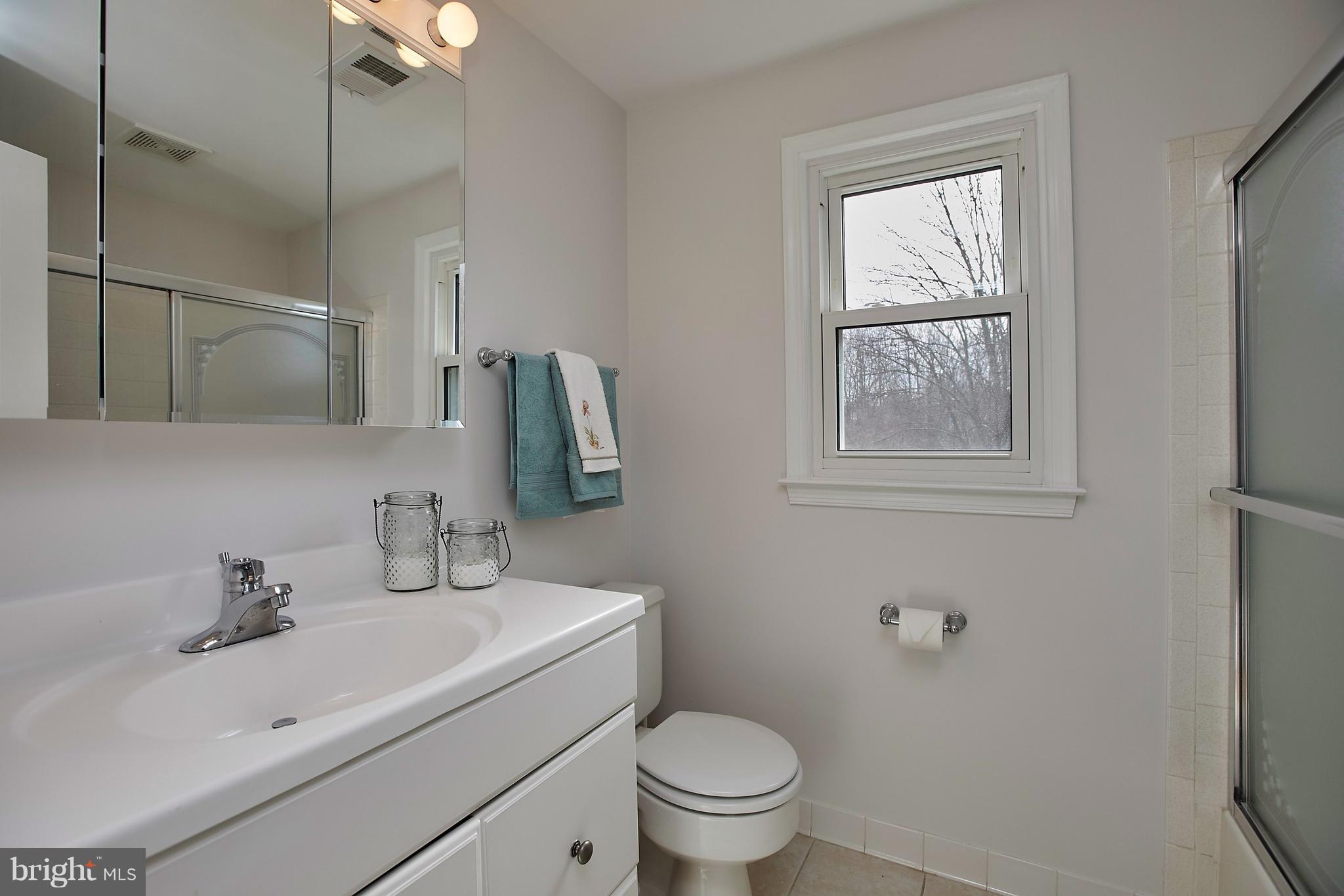 9961 Meadowlark Road Vienna, VA 22182 - Photo 22 of 30 a bathroom with a sink toilet and vanity