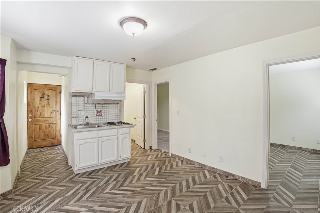 1581 West Chanticleer Road, Unit B Anaheim, CA 92802 - Photo 2 of 13 a kitchen with granite countertop a sink stove and refrigerator