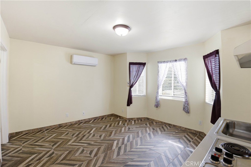 1581 West Chanticleer Road, Unit B Anaheim, CA 92802 - Photo 3 of 13 a view of a bedroom with window and hardwood floor