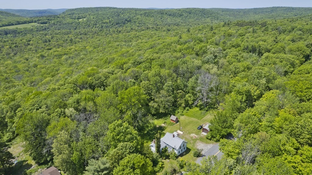 806 Colebrook River Road Tolland, MA 01034 - Photo 1 of 17 a view of a lush green field