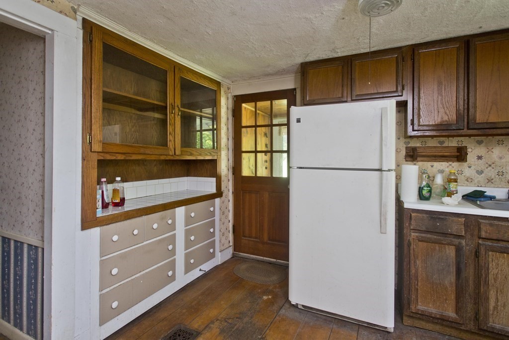 806 Colebrook River Road Tolland, MA 01034 - Photo 4 of 17 a kitchen with stainless steel appliances granite countertop a refrigerator and a cabinets
