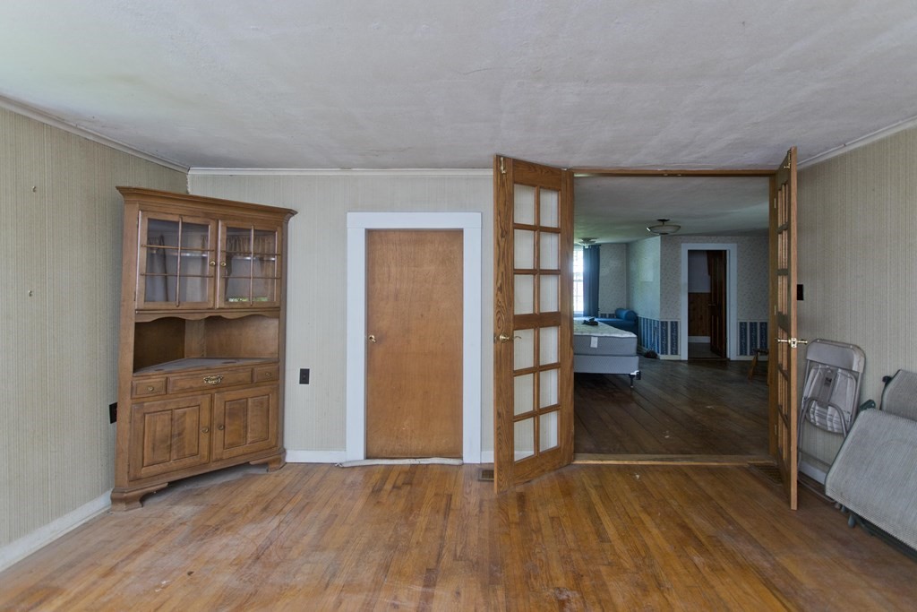 806 Colebrook River Road Tolland, MA 01034 - Photo 8 of 17 wooden floor in an empty room and a kitchen