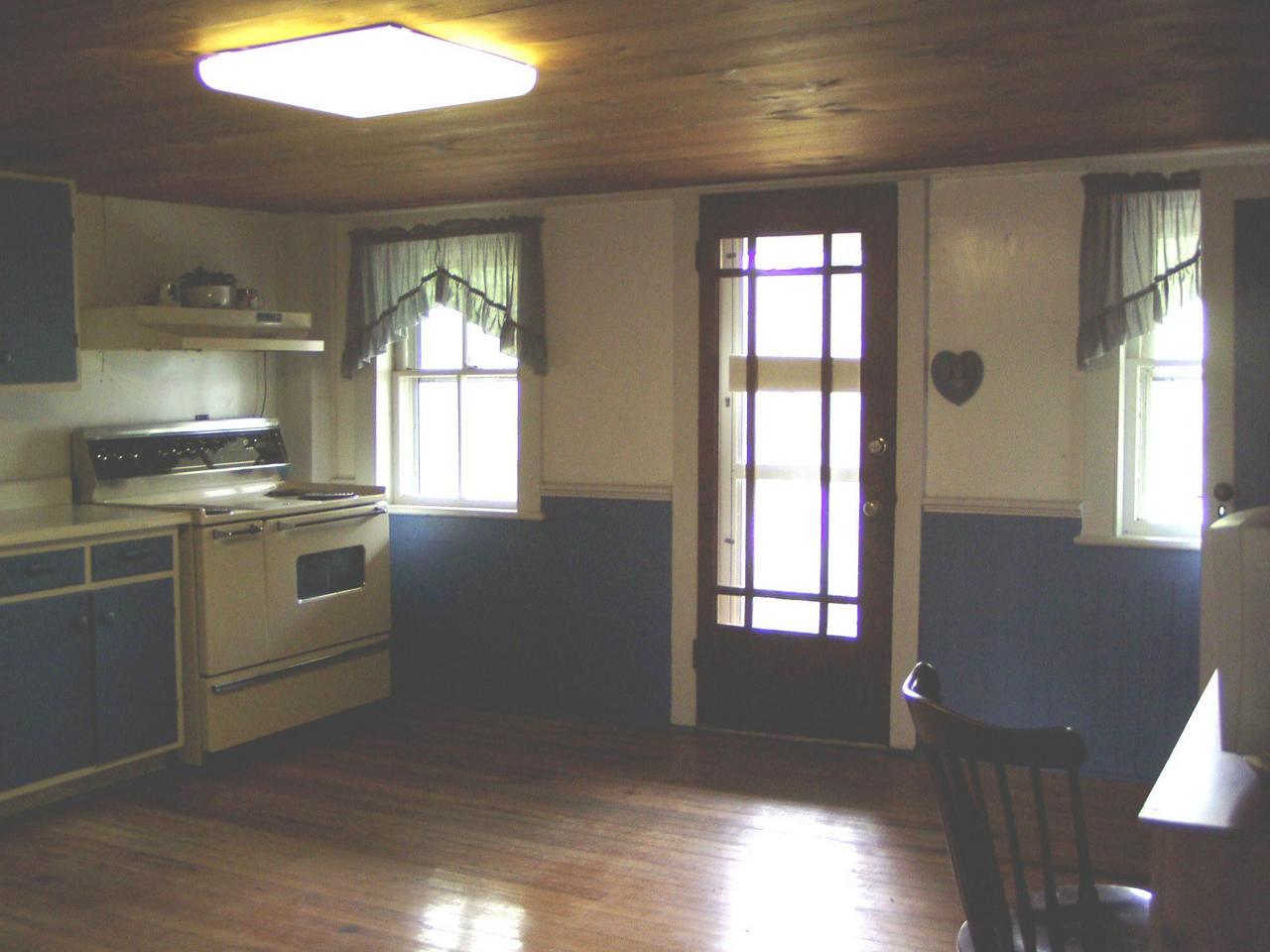 Spruce Cabin Road Cresco, PA 18326 - Photo 17 of 17 a kitchen with granite countertop white cabinets and white appliances