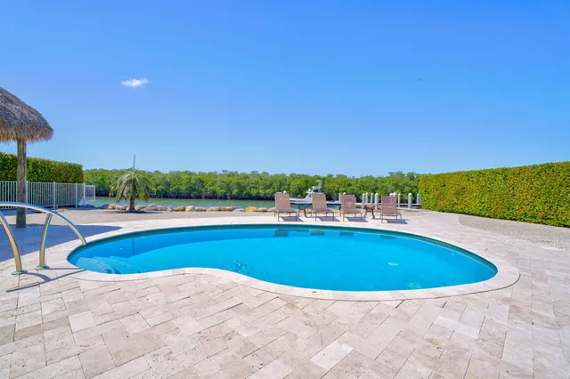 a view of a swimming pool and a yard