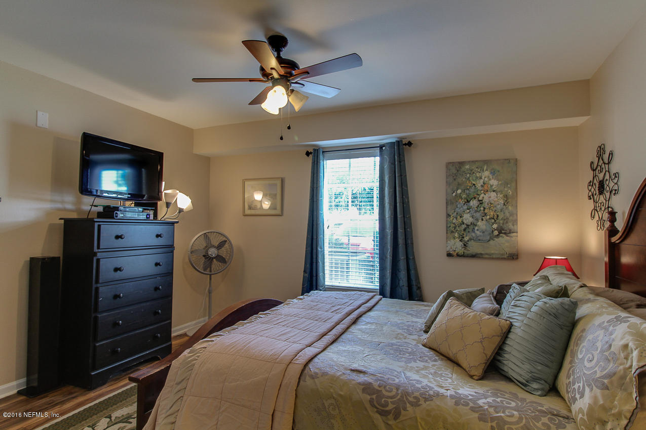23583 Bahama Point Fernandina Beach, FL 32034 - Photo 14 of 37 a bedroom with a bed and a flat screen tv