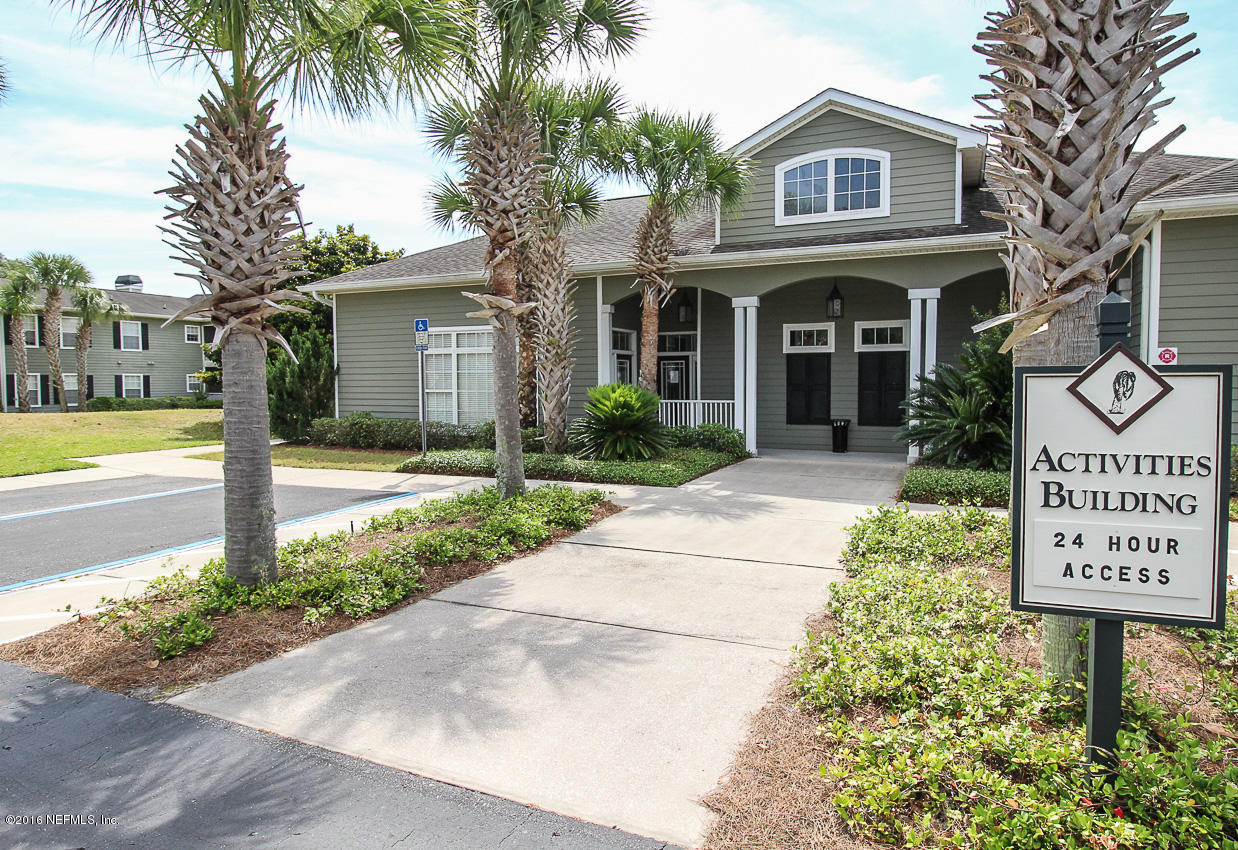 23583 Bahama Point Fernandina Beach, FL 32034 - Photo 26 of 37 a view of a brick house with a large tree