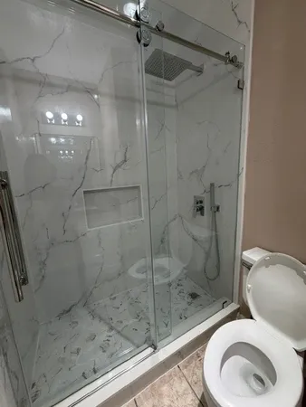 a bathroom with a toilet and a shower