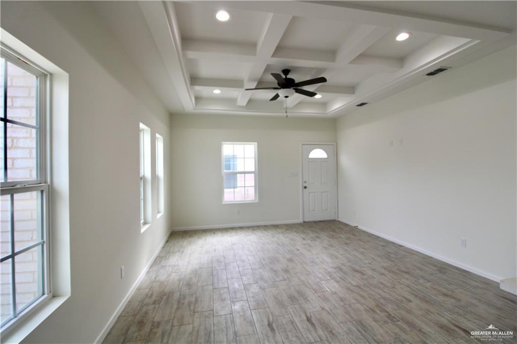 1610 Hooper Street, Unit 10 San Juan, TX 78589 - Photo 2 of 14 wooden floor in an empty room with a window