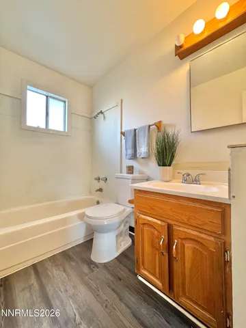 a bathroom with a sink a toilet and bathtub