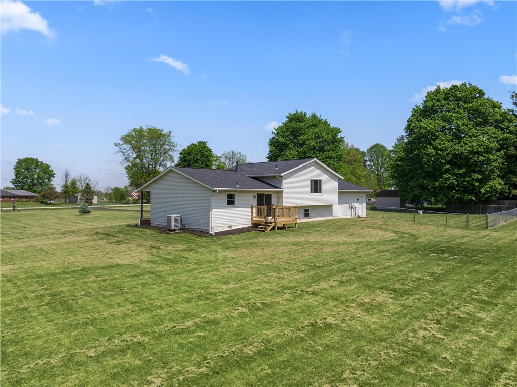 1353 Foust Road Xenia, OH 45385 - Photo 22 of 50 This residence features a deck for outdoor enjoyment, a spacious yard, and a practical chain-link fence.