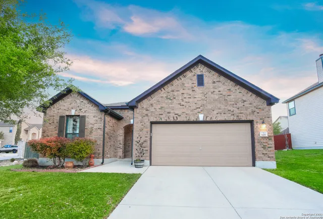 a front view of house with yard and green space