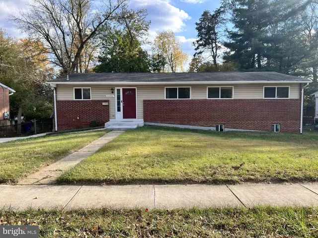 a front view of a house with a garden and yard