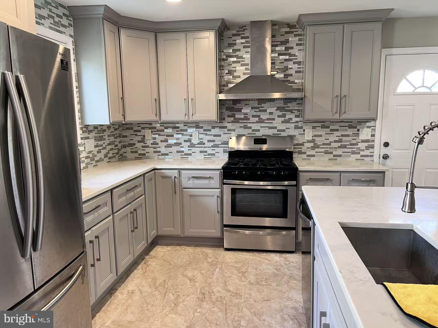 4106 Southend Road Rockville, MD 20853 - Photo 14 of 36 a kitchen with a stove a refrigerator and a sink