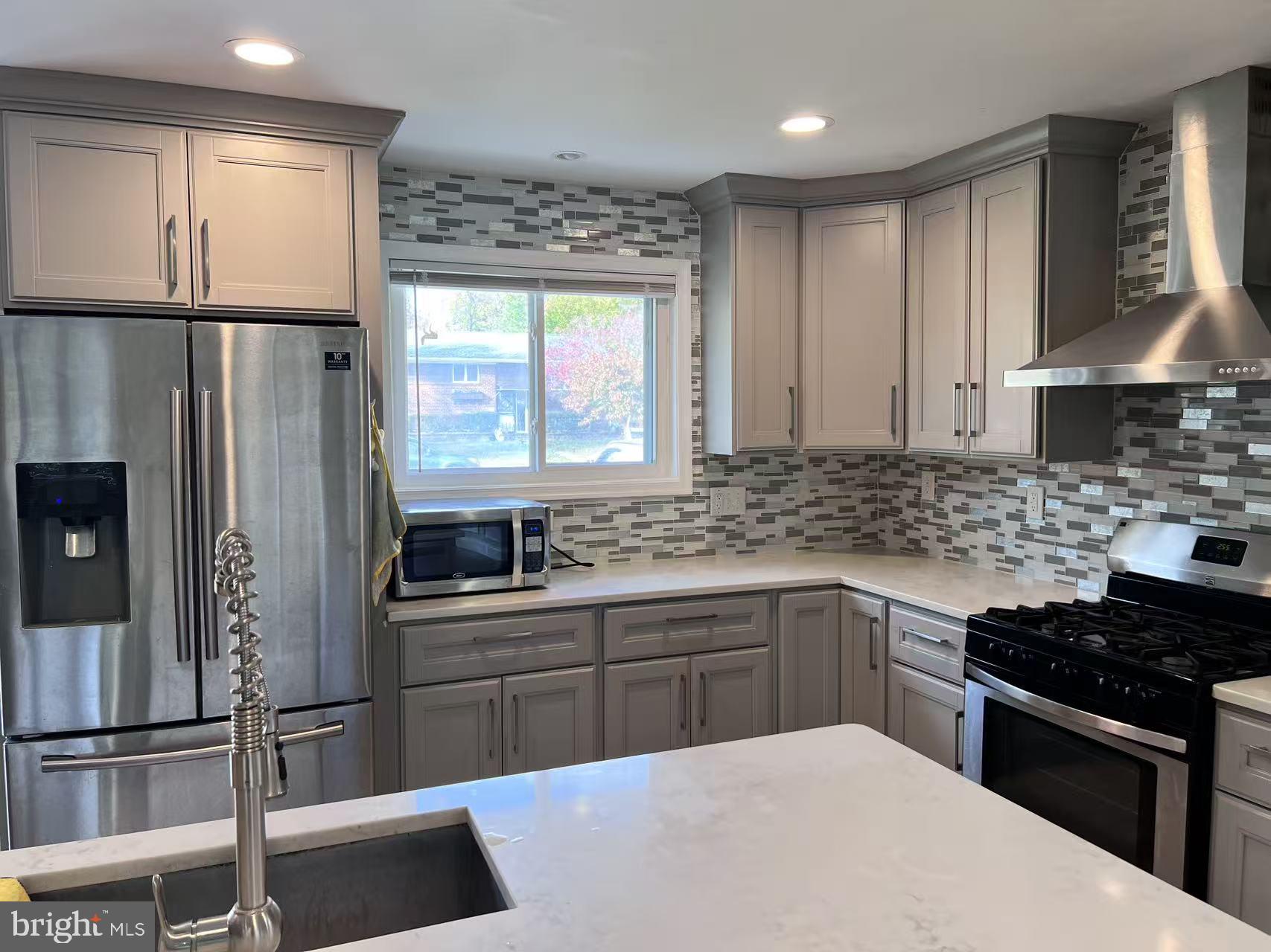 4106 Southend Road Rockville, MD 20853 - Photo 16 of 36 a kitchen with stainless steel appliances a sink stove and refrigerator