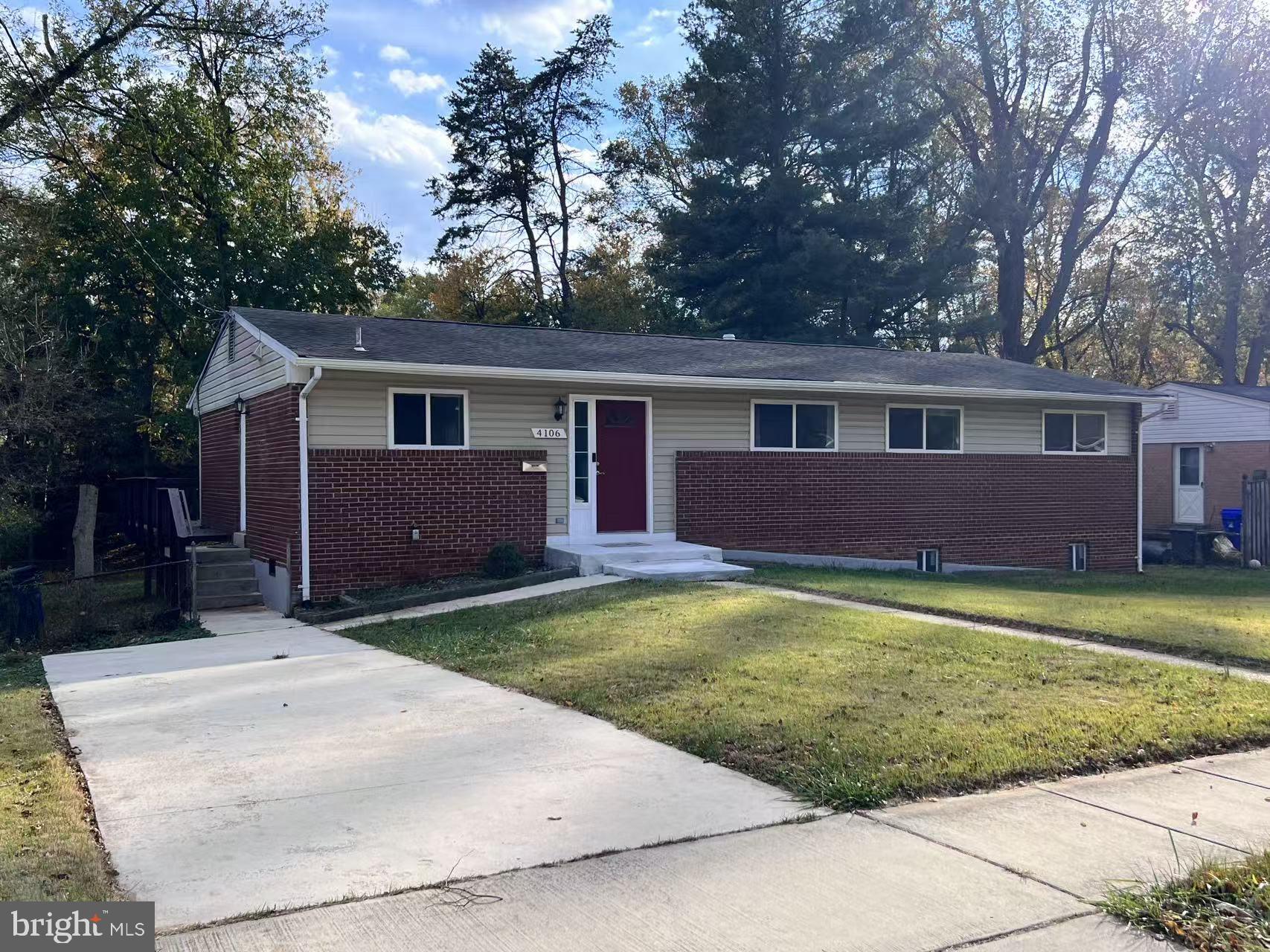 4106 Southend Road Rockville, MD 20853 - Photo 2 of 36 a front view of a house with a garden