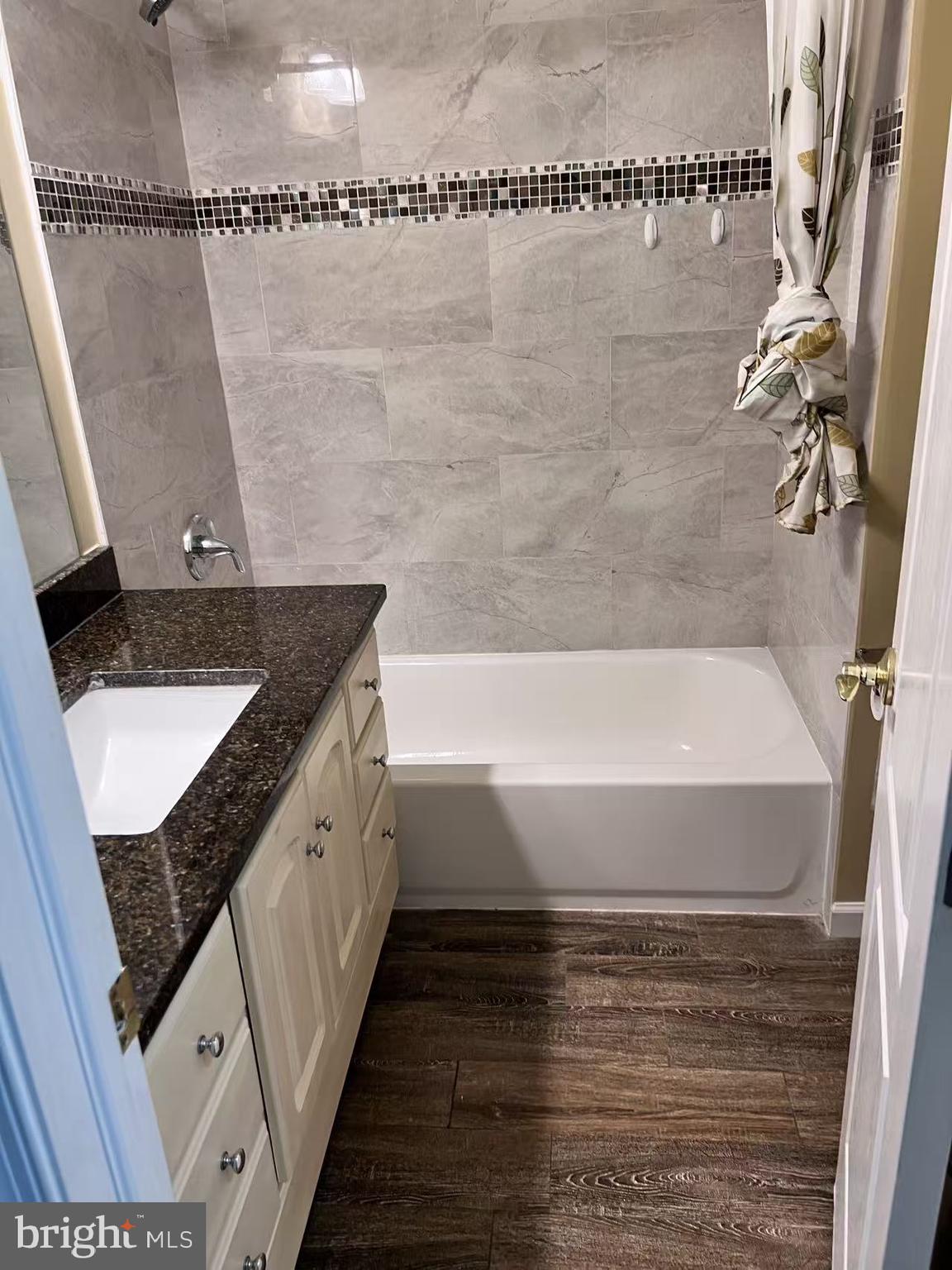4106 Southend Road Rockville, MD 20853 - Photo 21 of 36 a spacious bathroom with a granite countertop sink and a bathtub