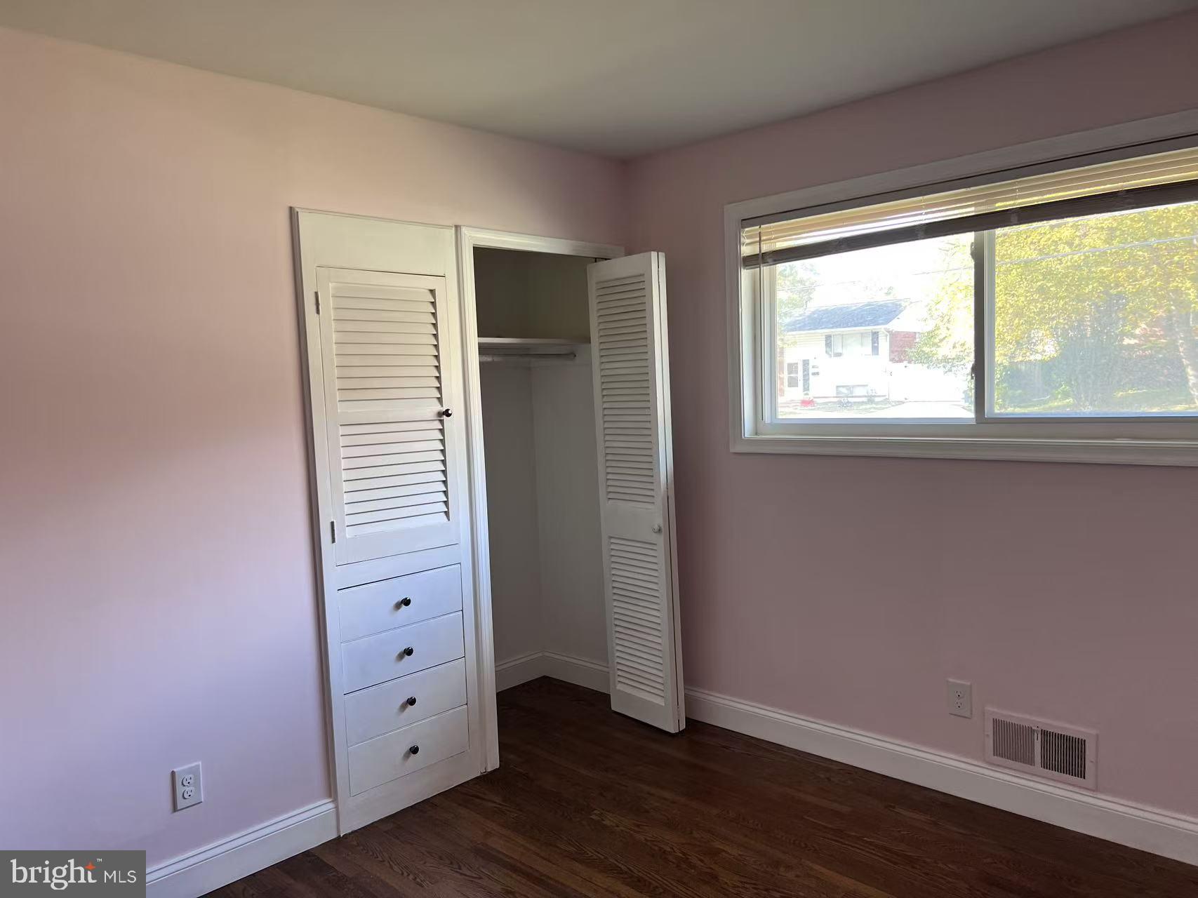 4106 Southend Road Rockville, MD 20853 - Photo 23 of 36 an empty room with wooden floor closet and windows