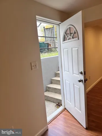 a view of front door with wooden floor