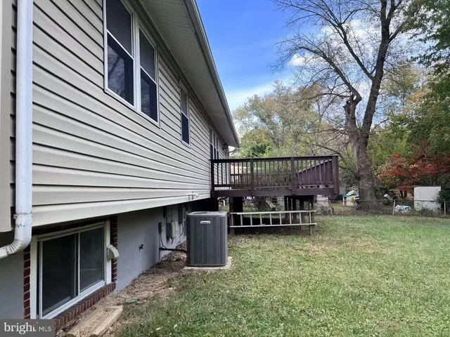 a wooden bench sitting in front of a house