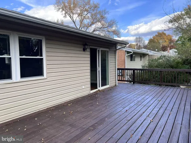a view of a house with a wooden deck