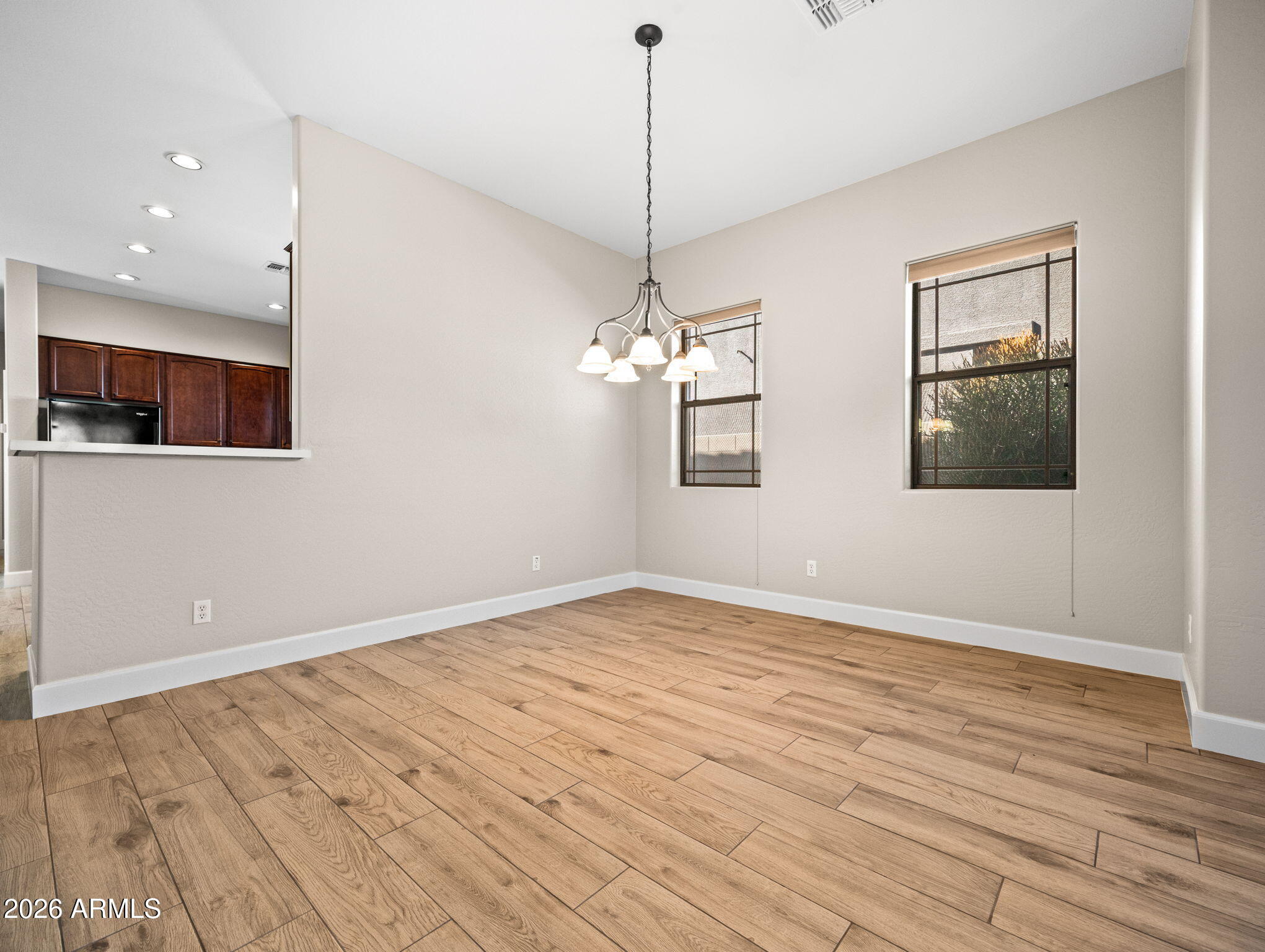 6202 East McKellips Road, Unit 83 Mesa, AZ 85215 - Photo 12 of 54 a view of empty room with wooden floor and fan