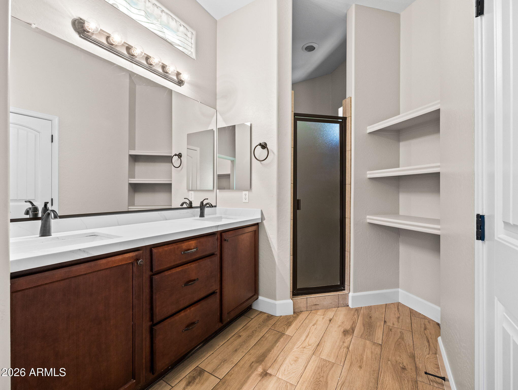 6202 East McKellips Road, Unit 83 Mesa, AZ 85215 - Photo 15 of 54 a bathroom with a double vanity sink a mirror and a shower