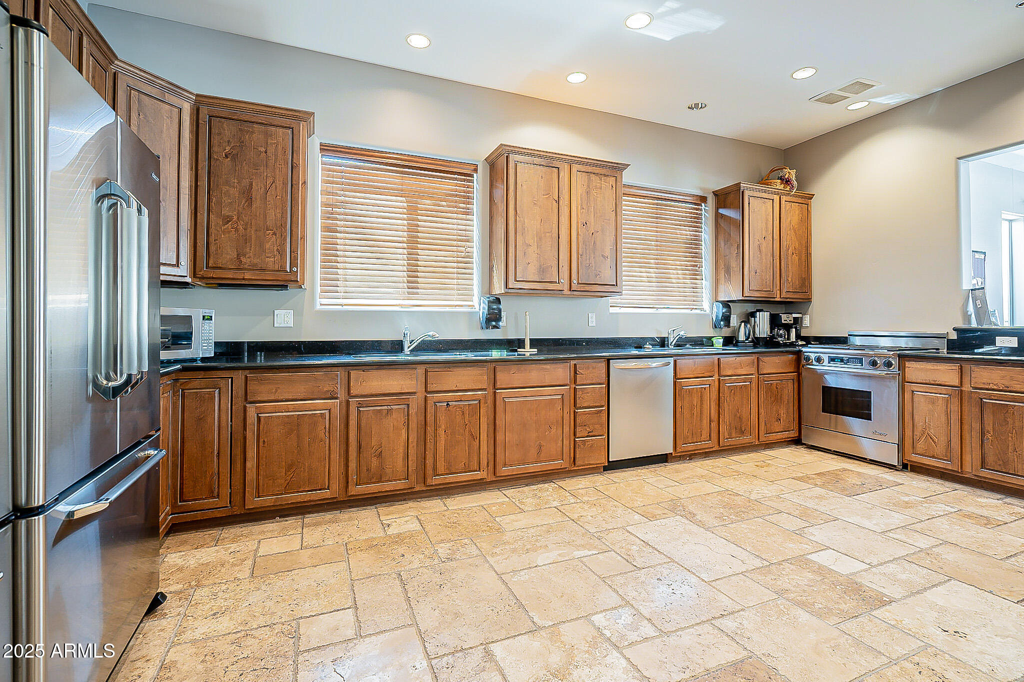 6202 East McKellips Road, Unit 83 Mesa, AZ 85215 - Photo 43 of 54 a large kitchen with granite countertop a stove sink and cabinets