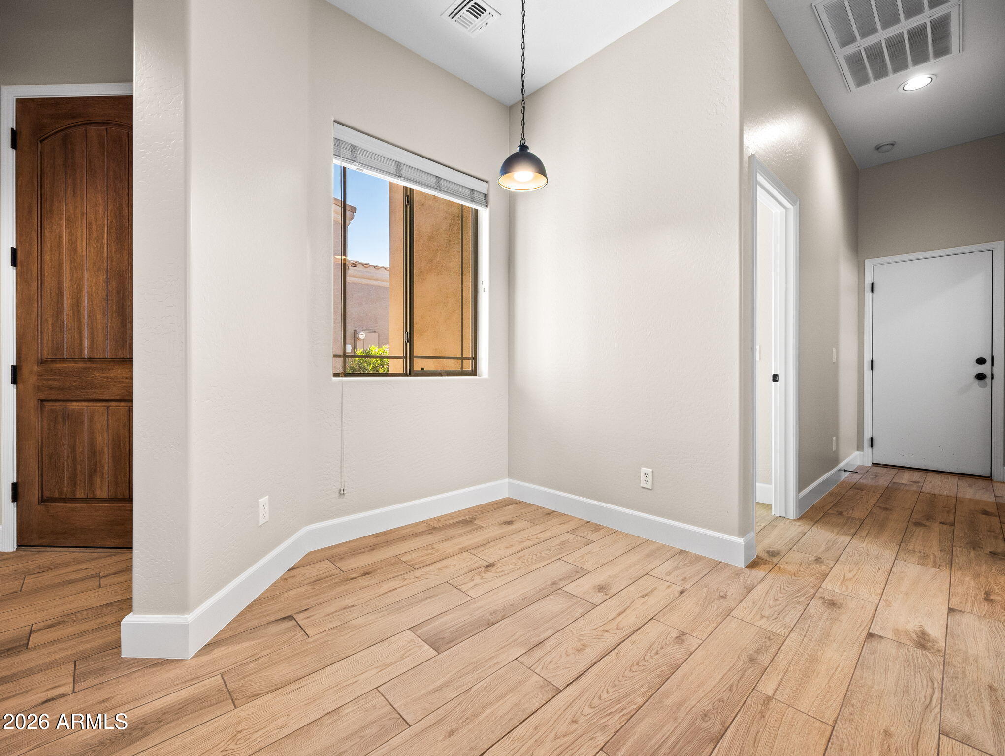 6202 East McKellips Road, Unit 83 Mesa, AZ 85215 - Photo 5 of 54 a view of empty room with wooden floor and fan