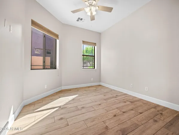 wooden floor in an empty room with a window