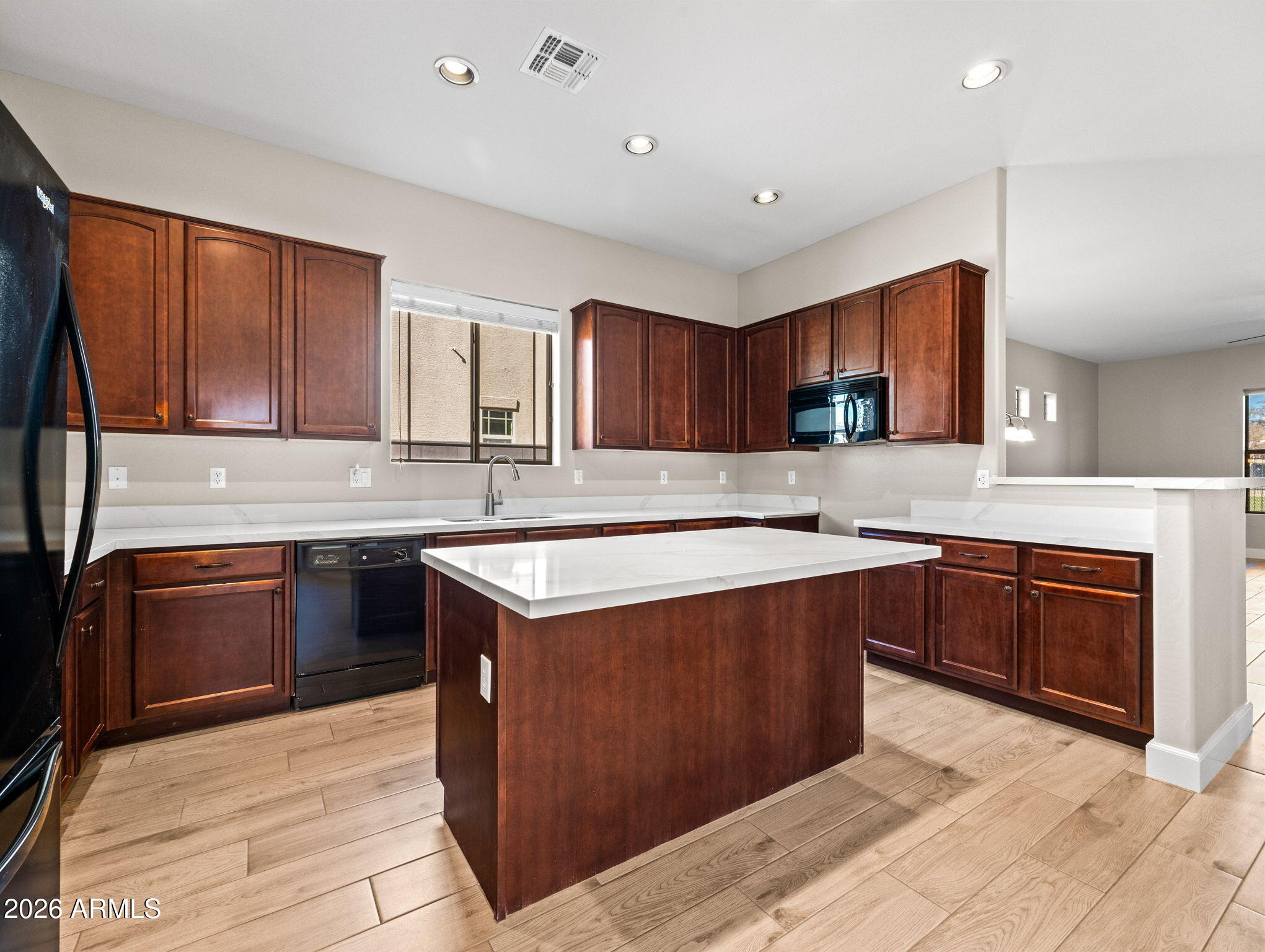 6202 East McKellips Road, Unit 83 Mesa, AZ 85215 - Photo 9 of 54 a kitchen with stainless steel appliances granite countertop wooden cabinets a stove top oven a sink and dishwasher