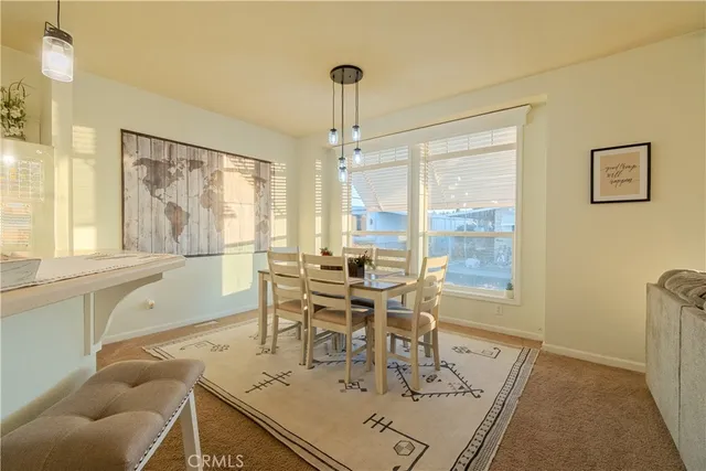 a dining room with furniture and window