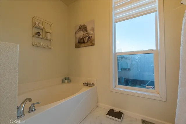 a bathroom with a tub and a shower