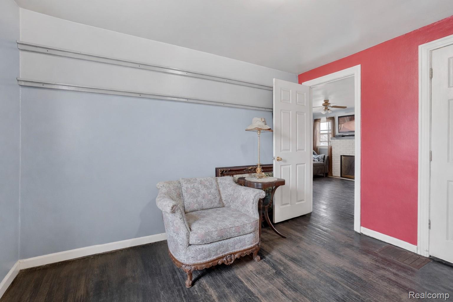 13343 Fenton Road Fenton, MI 48430 - Photo 13 of 45 Sitting room featuring a fireplace and dark wood-style flooring