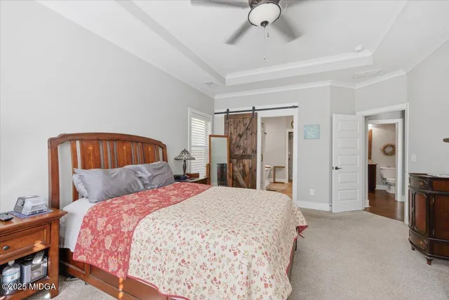 a bedroom with a bed a chandelier and a window