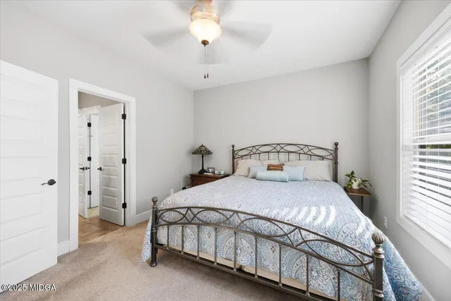 a living room with patio furniture and a floor to ceiling window