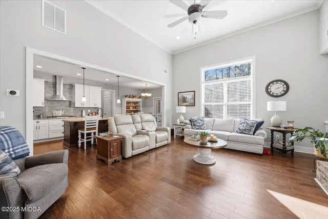 a living room with furniture and wooden floor
