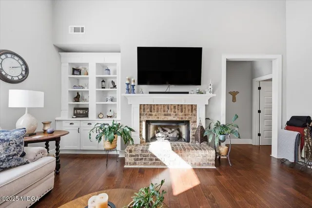 a living room with furniture fireplace and flat screen tv