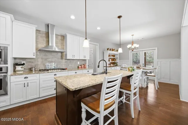 a kitchen with a table chairs stove and kitchen view