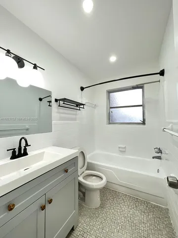 a bathroom with a sink a toilet and a bathtub
