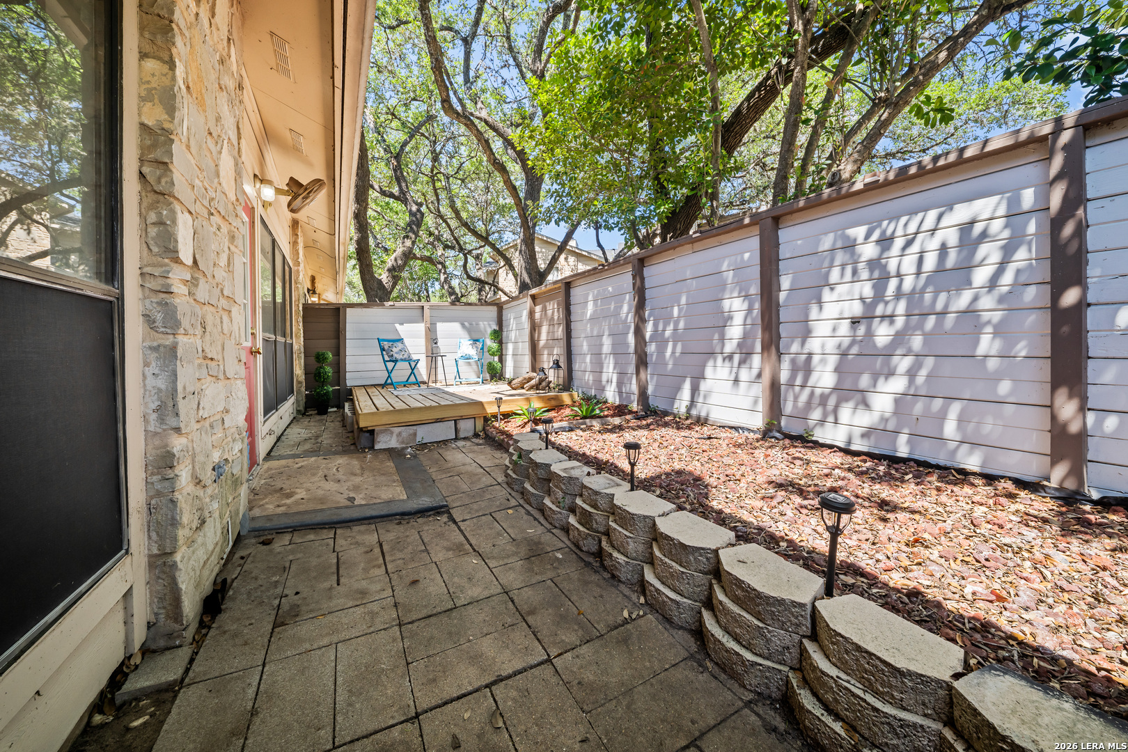 829 West Bitters Road, Unit 502 San Antonio, TX 78216 - Photo 22 of 29 a view of a backyard with table and chairs with wooden fence and plants