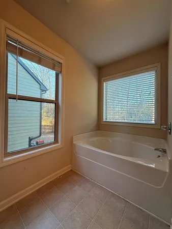a white bath tub sitting next to a window