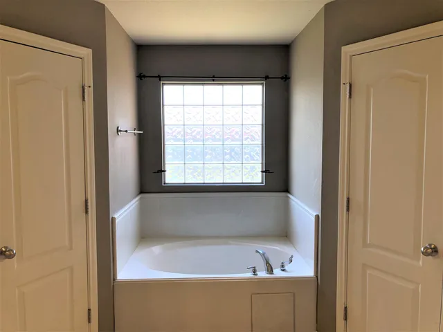 a bathroom with a bathtub and a shower